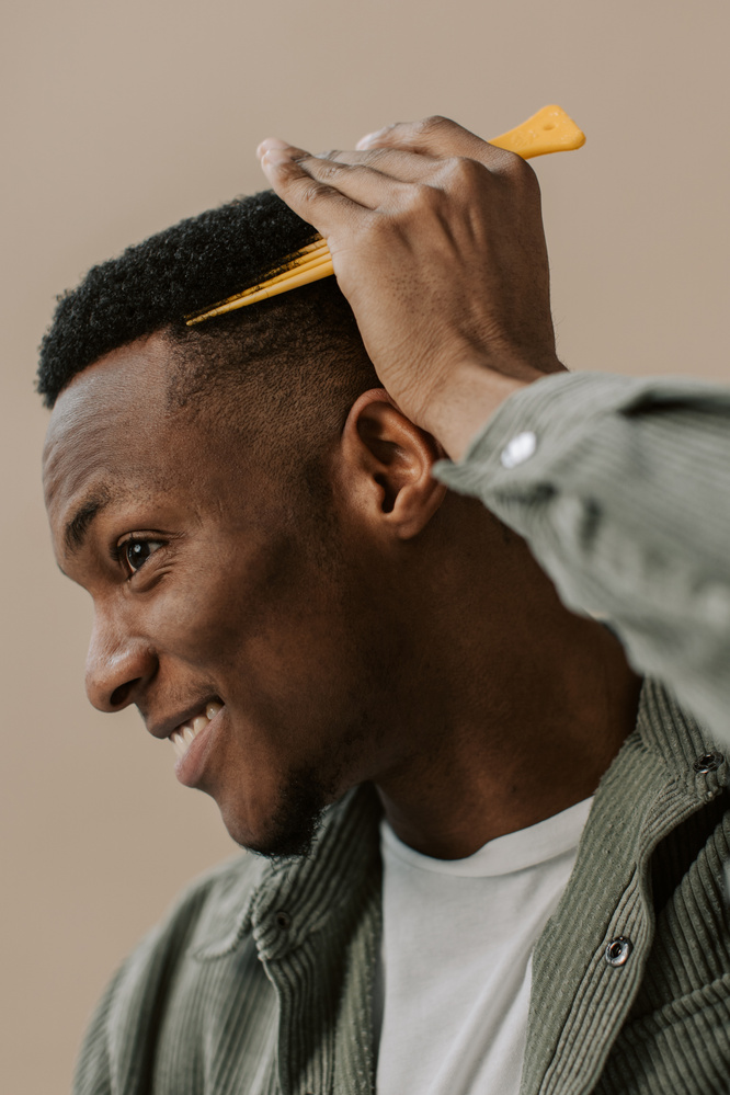Man with Hair Pick Combing Curly Hair